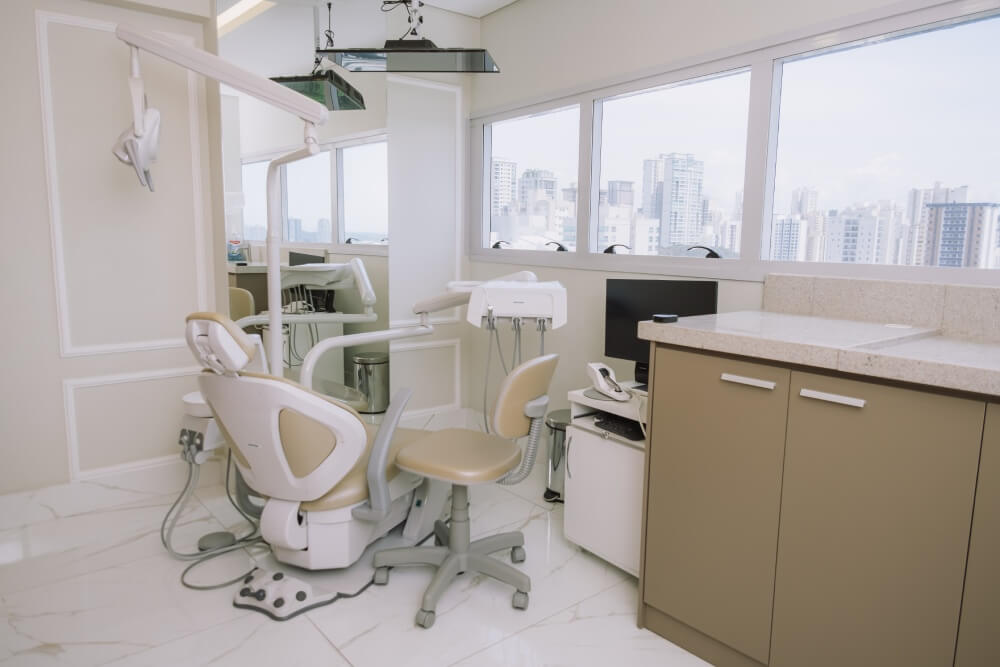 Consultório odontológico com cadeira moderna e vista panorâmica para a cidade na clínica odontológica em São José dos Campos Herrera Prime.